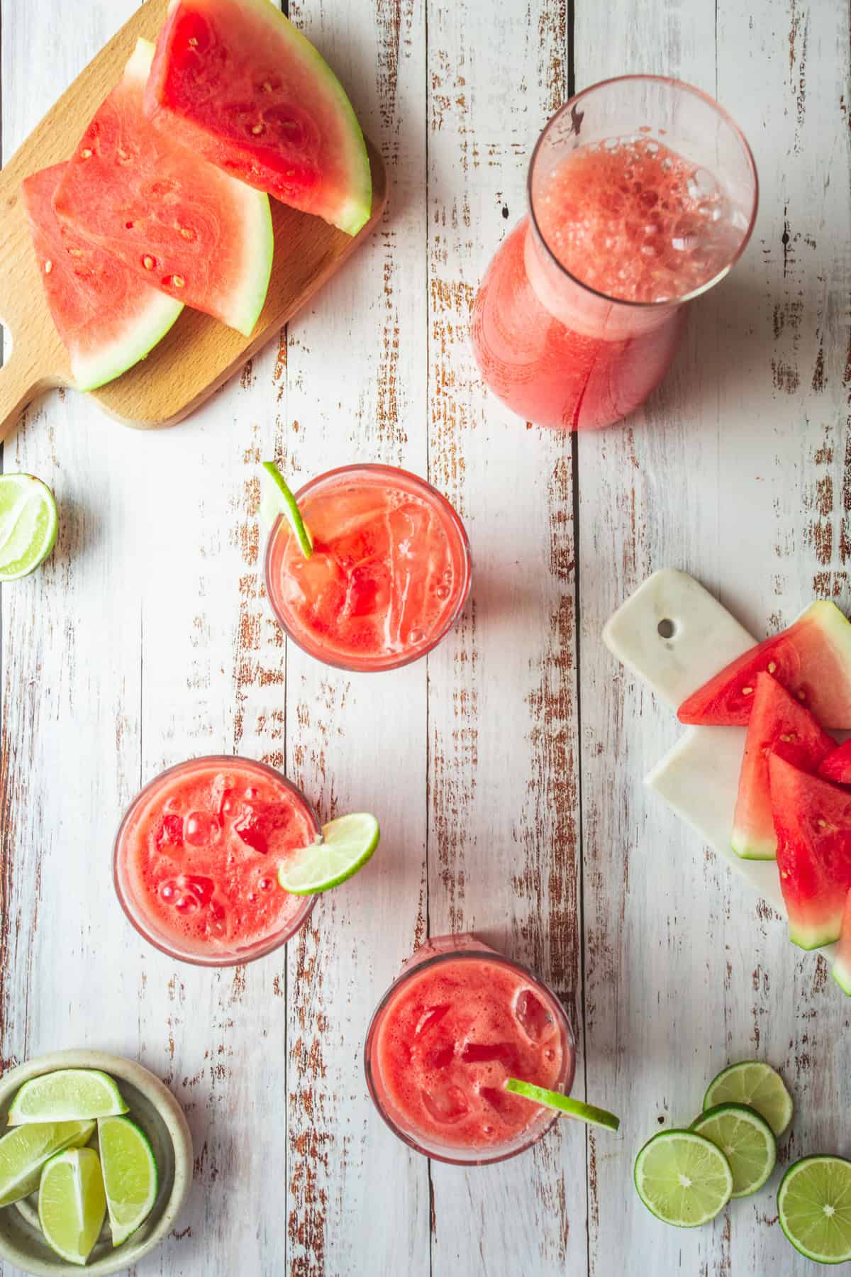 Refreshing watermelon and lime slices on a wooden table.