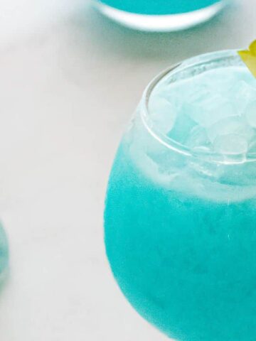 Two Blue Hawaiian Mocktails in glasses.