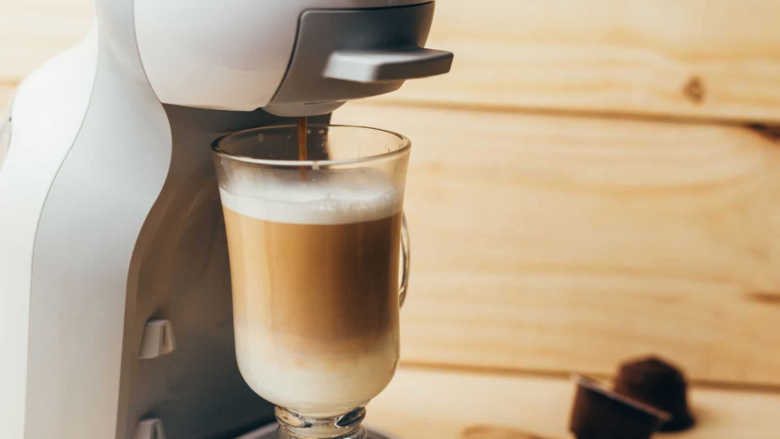 Glass being filled with espresso by a coffee machine