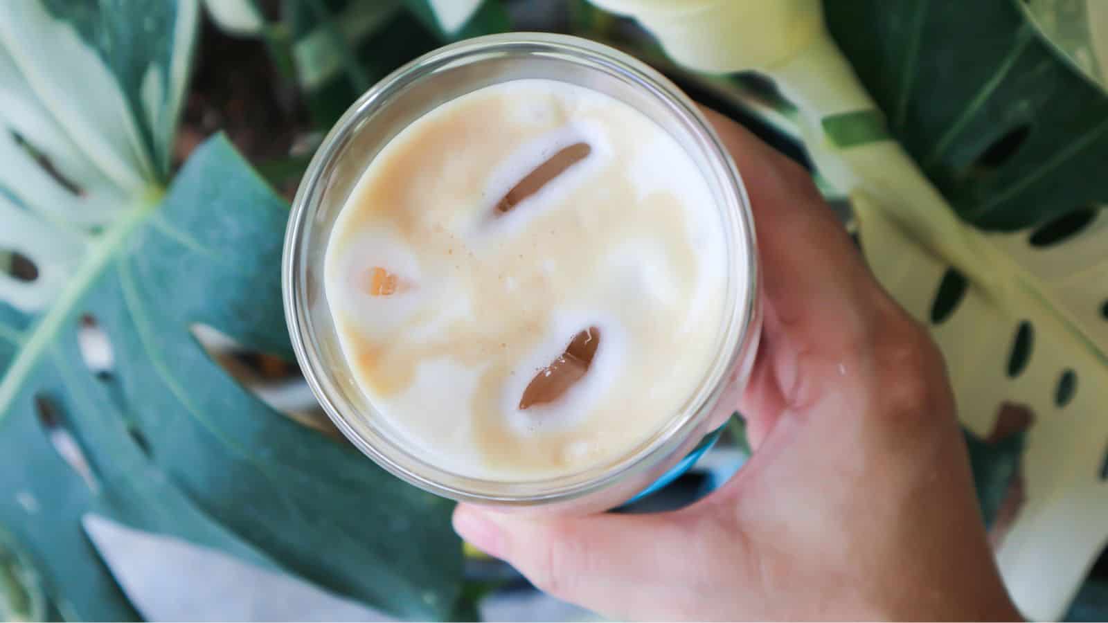 Top view of a glass of foamy coffee