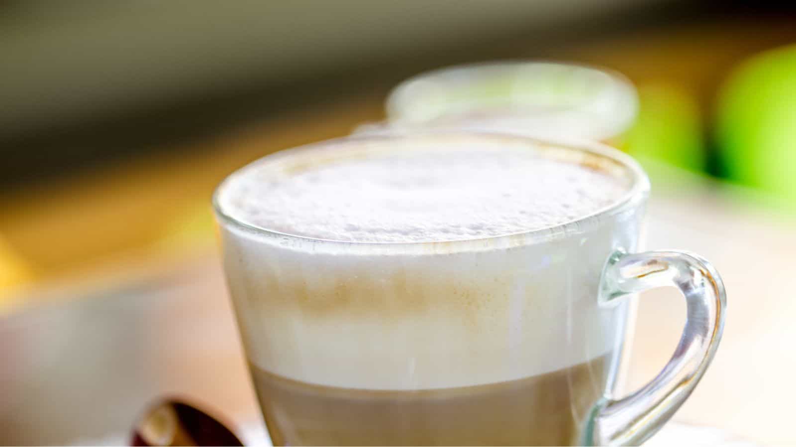 Glass of foamy coffee.