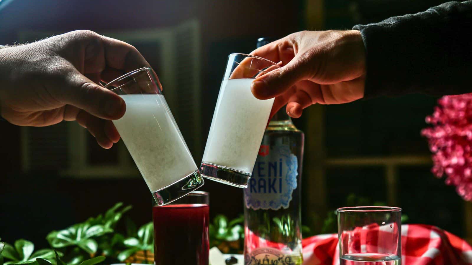Two glasses of raki being clinked together