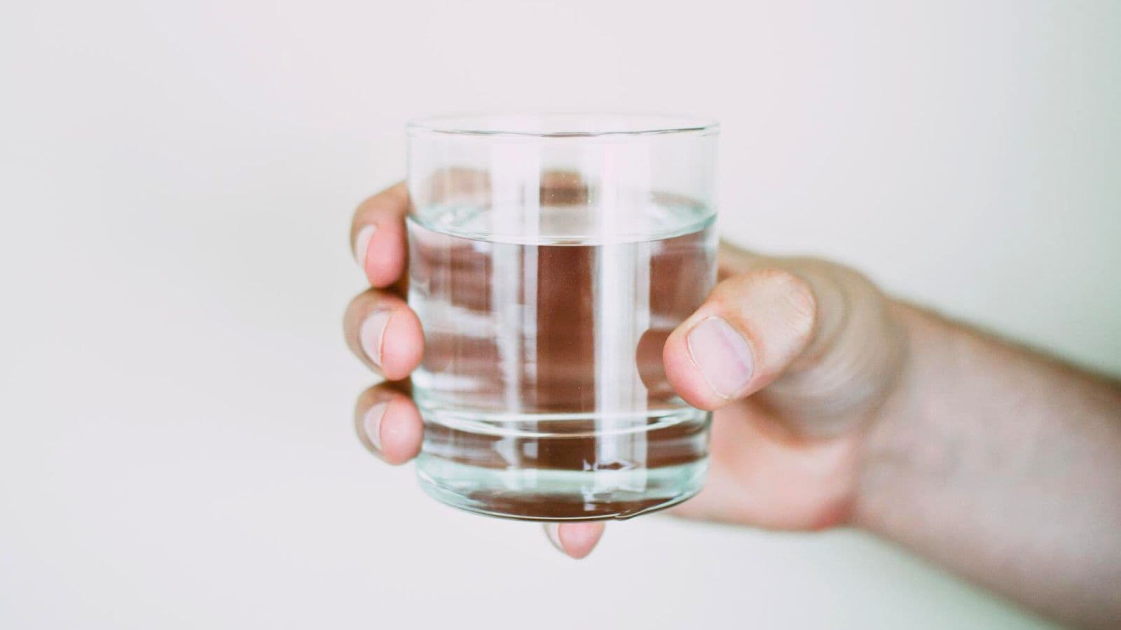 A glass of water held in one hand