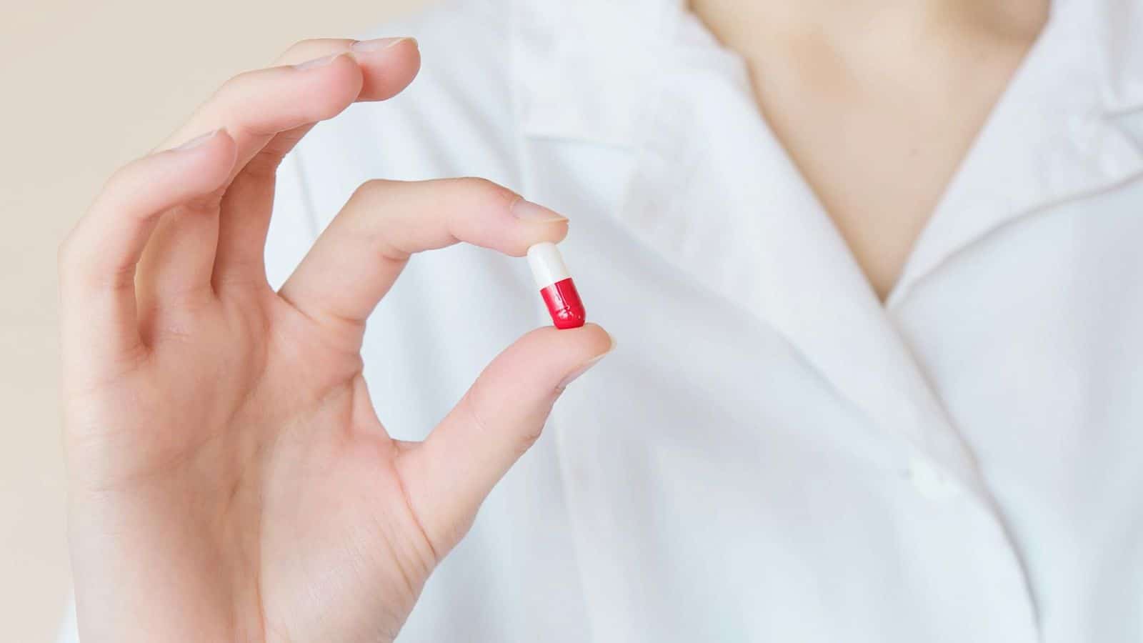 Person holding a pill