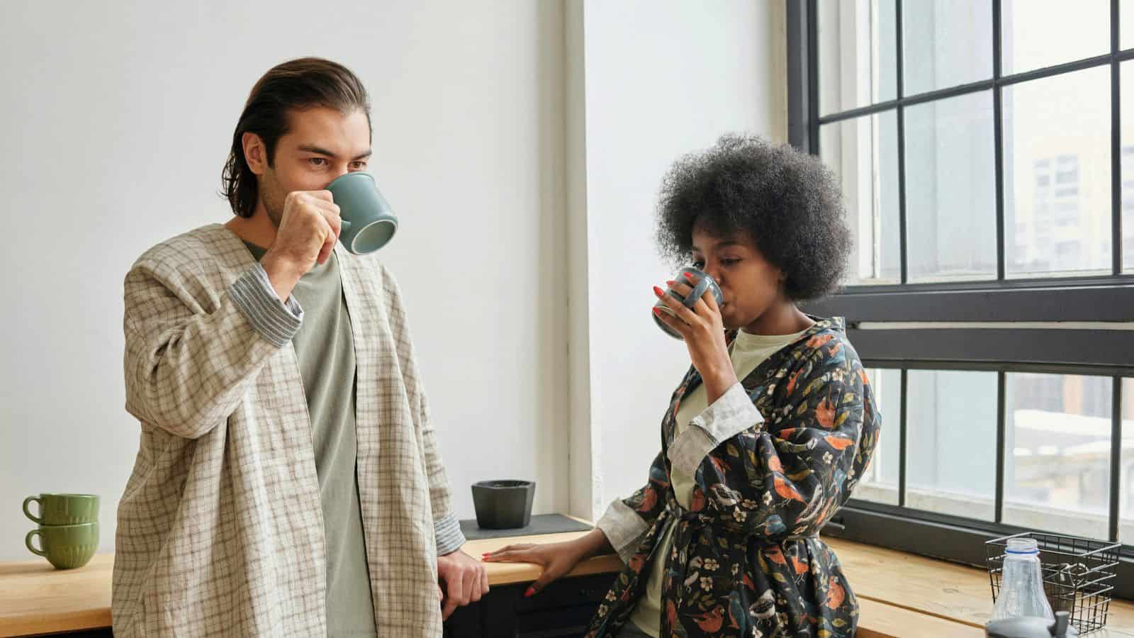 A man and woman drink coffee