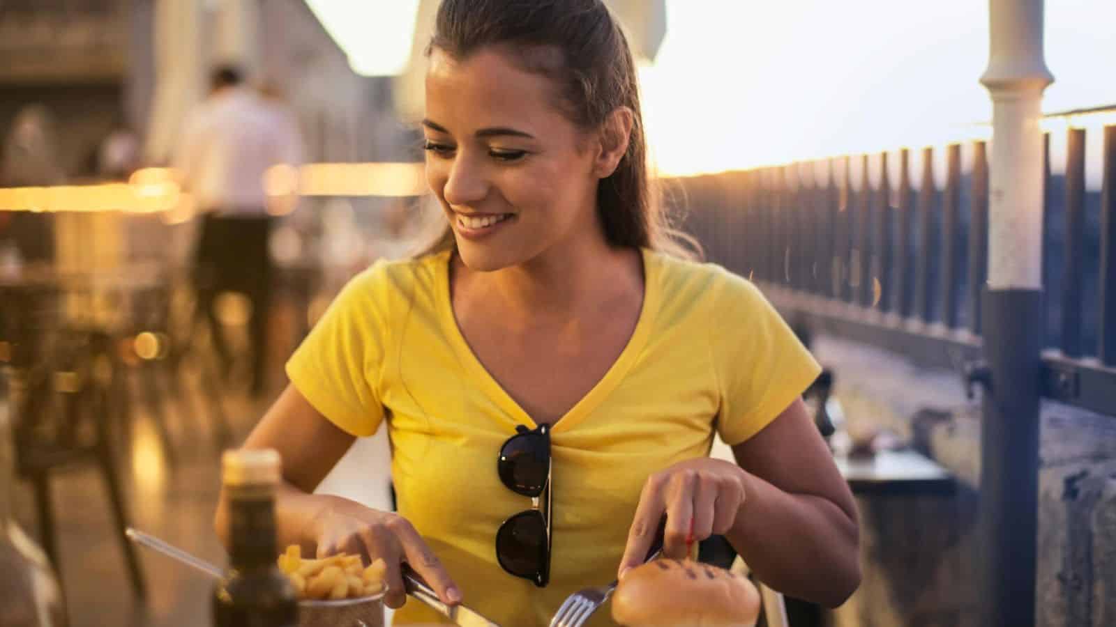 Woman eating burger and fries