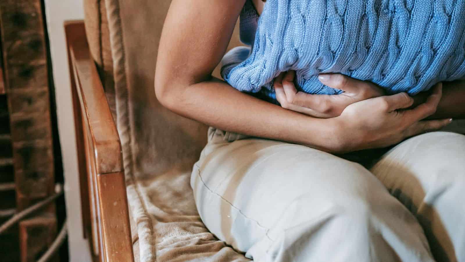 Person clutching their stomach