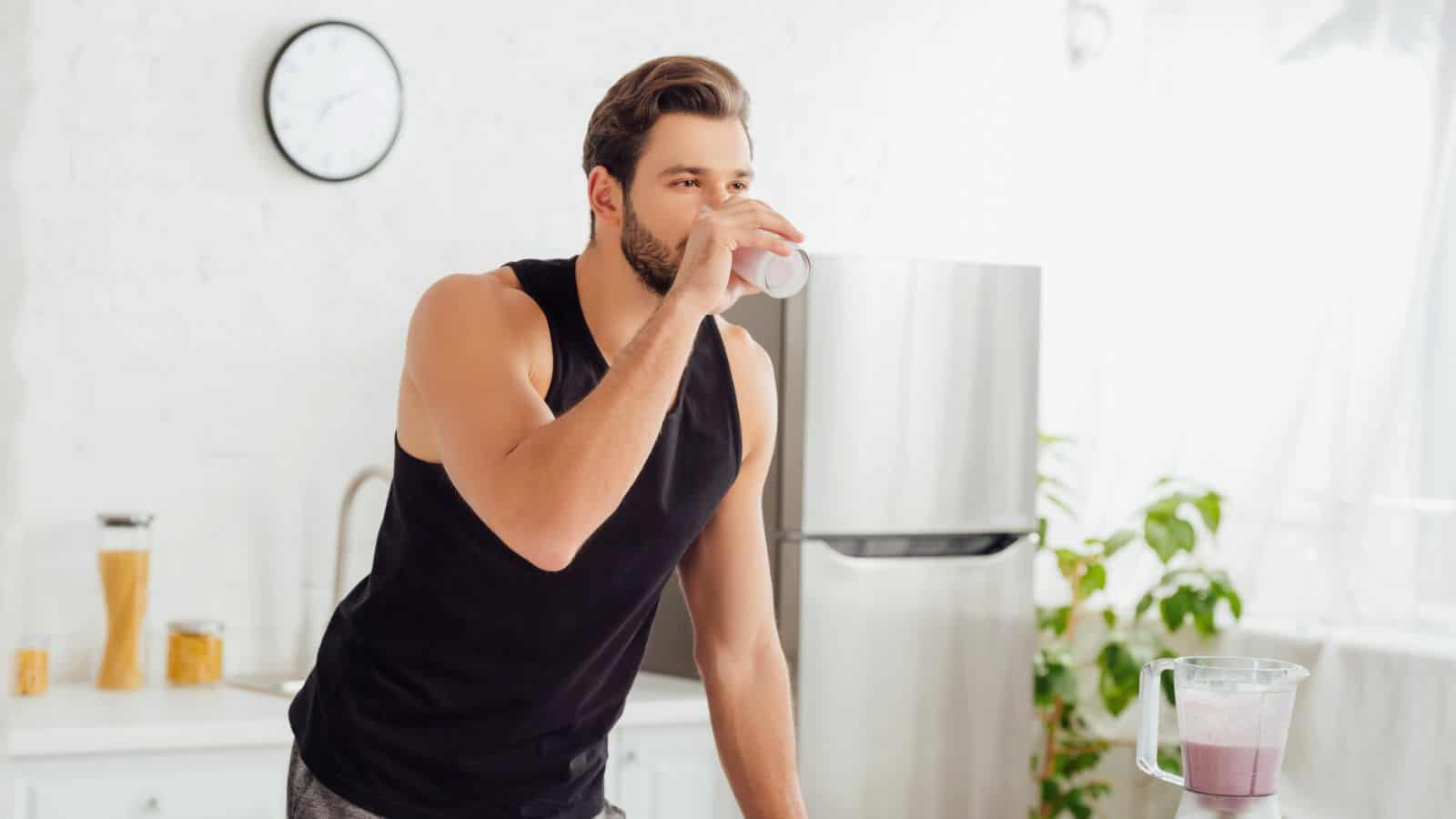 A man drinking a glass of something