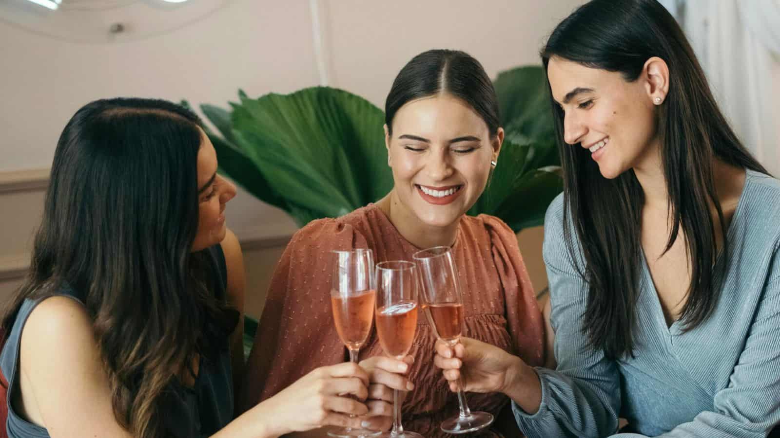 Group of friends clinking their champagne flutes together