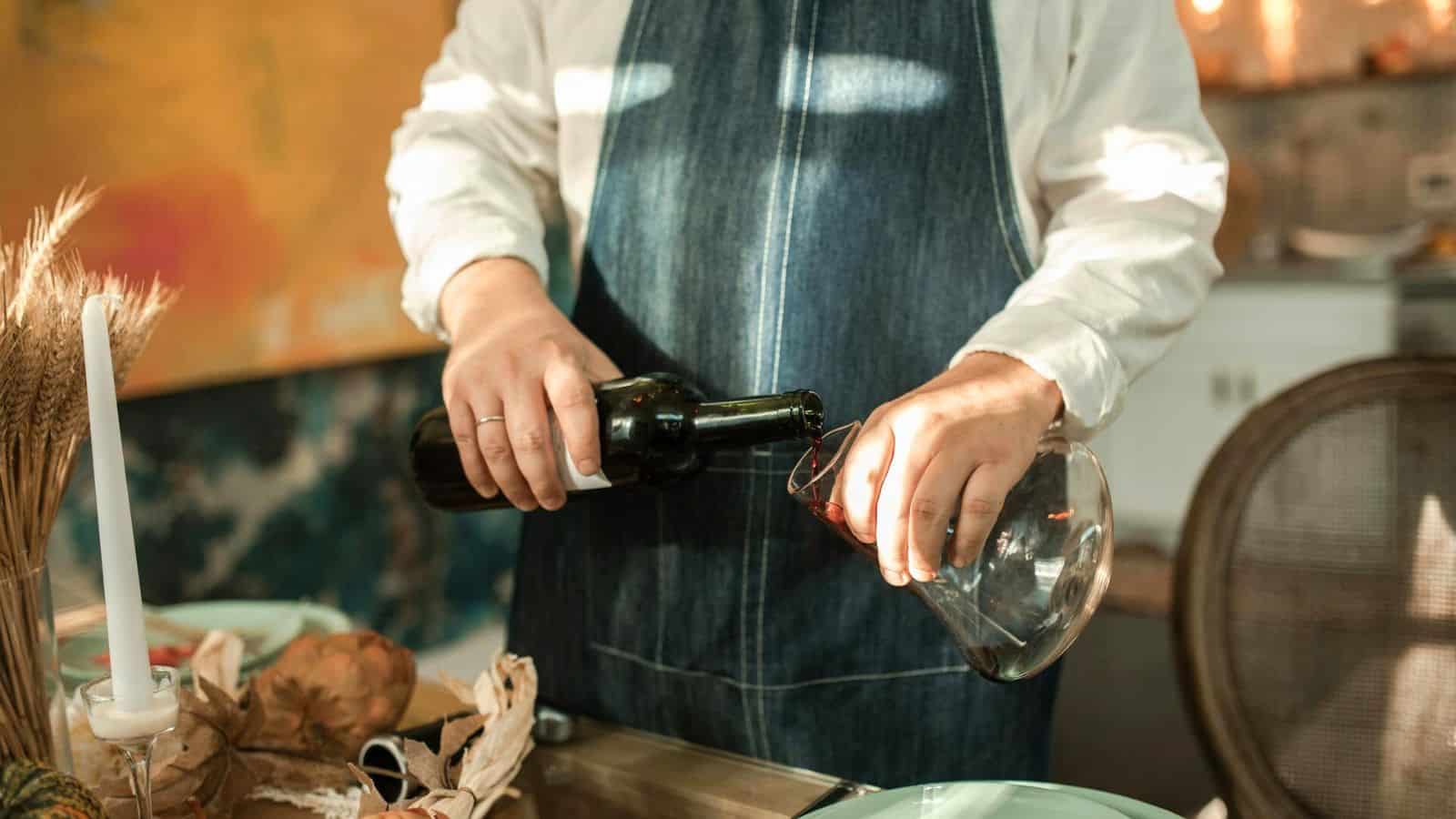 Person pouring wine onto a glass