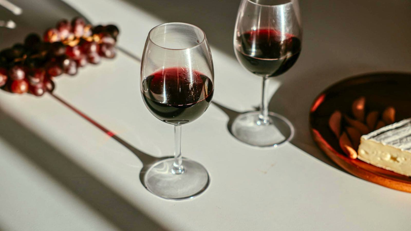 Two filled red wine glasses