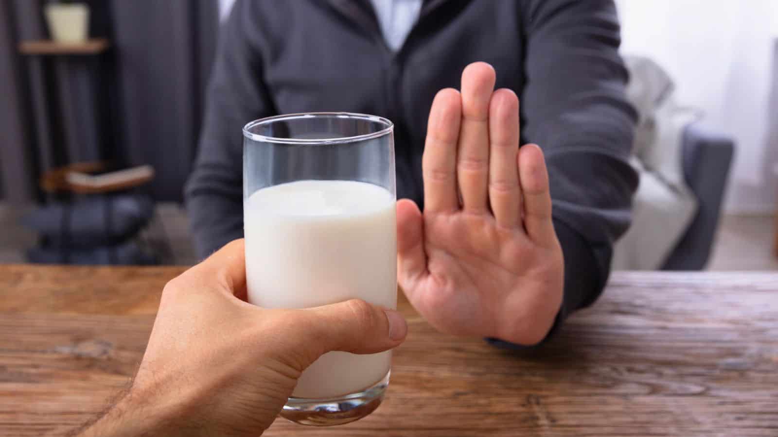Person refusing a glass of milk