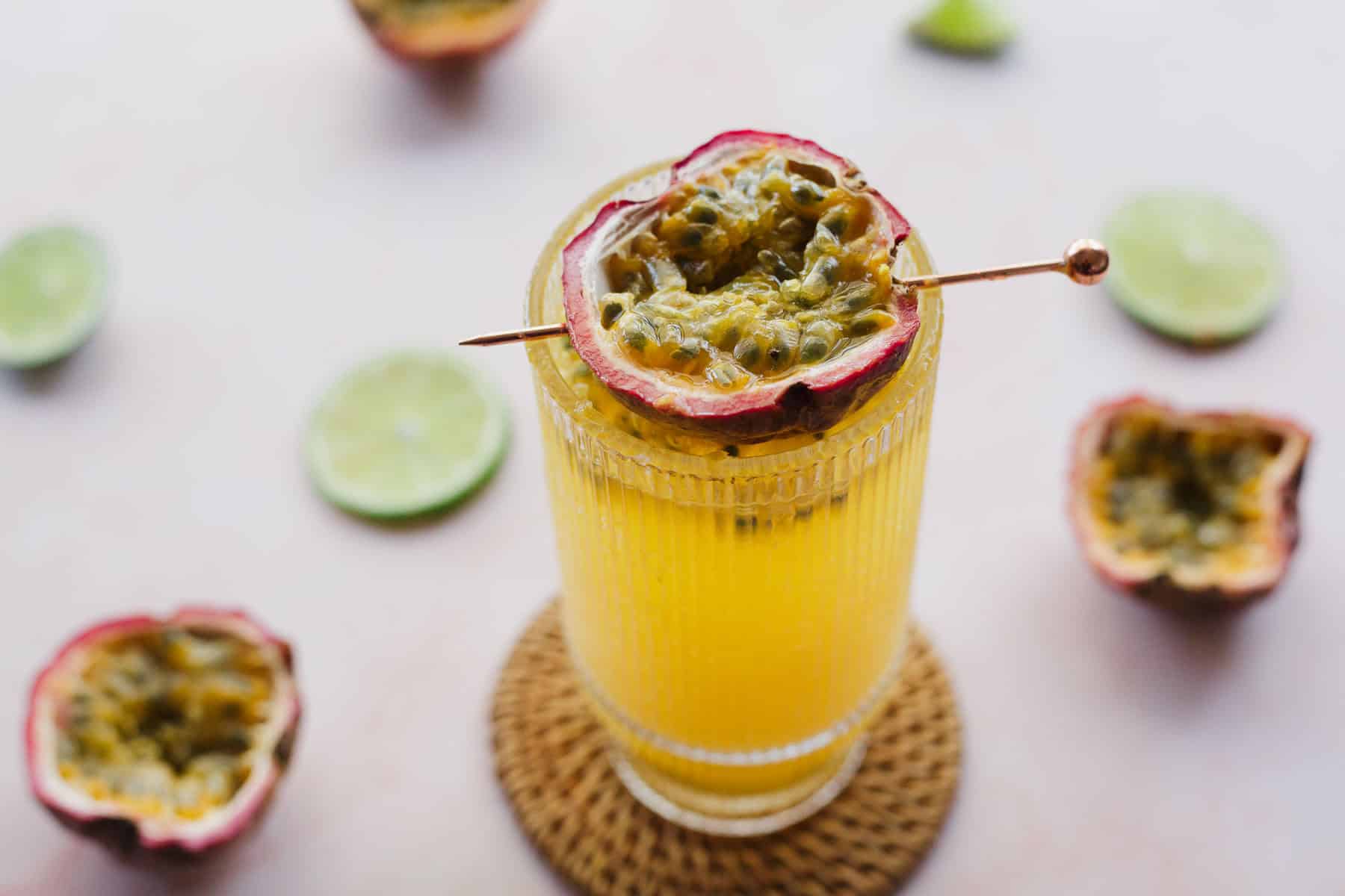 Overhead view of passionfruit mocktail with lime wedges around