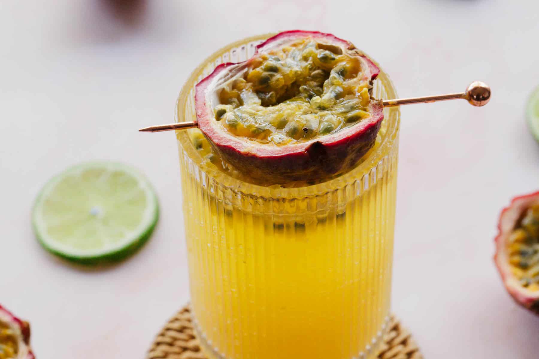 Overhead view of passionfruit mocktail with lime wedges around