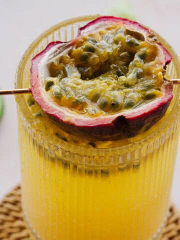 Overhead view of passionfruit mocktail with lime wedges around