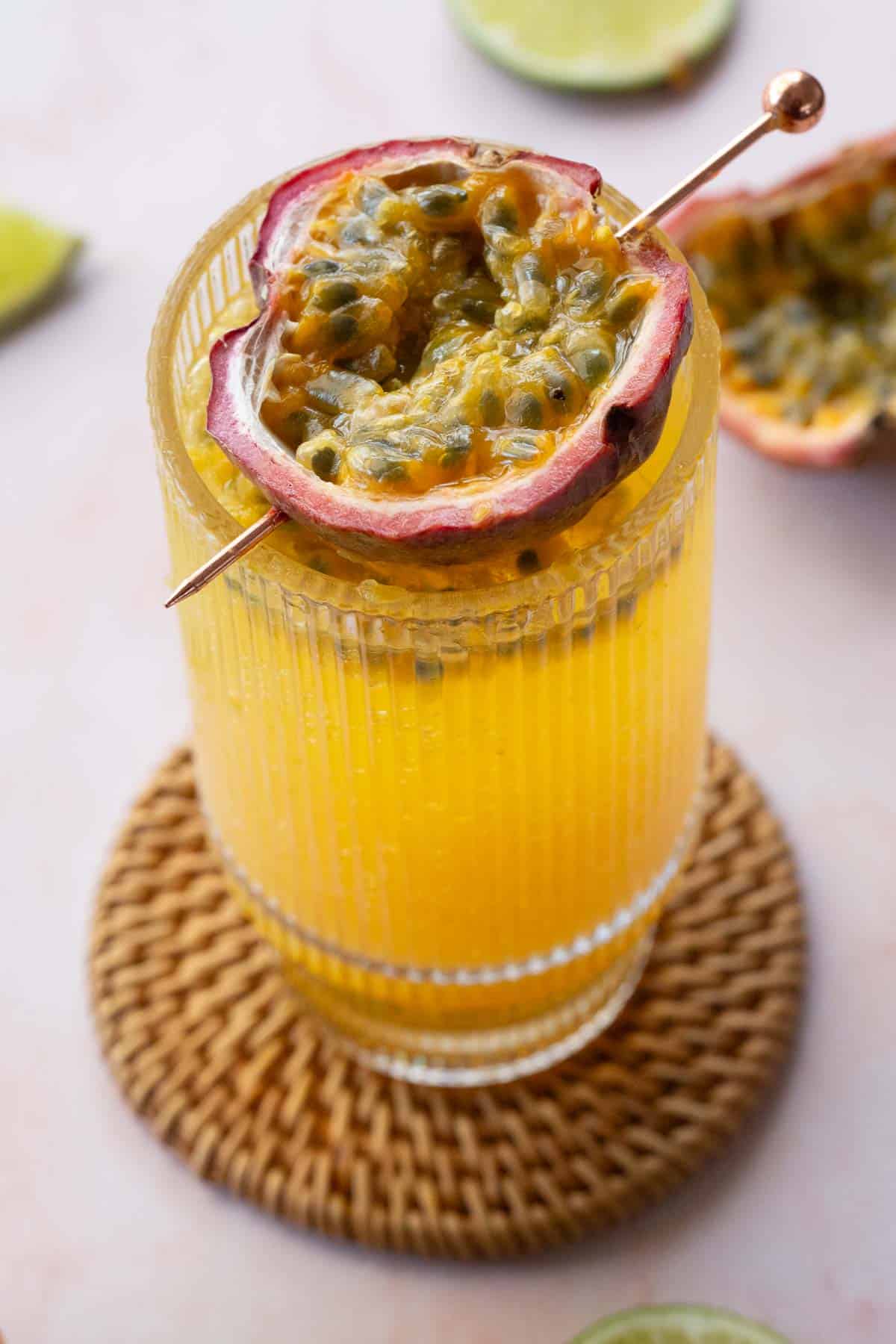 Overhead view of passionfruit mocktail with lime wedges around