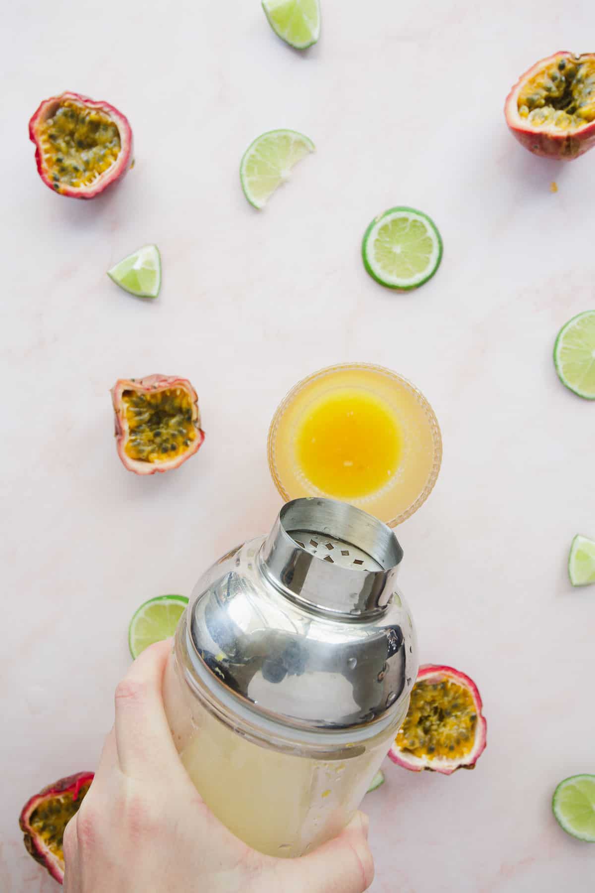 Pouring mocktail ingredients from shaker to glass