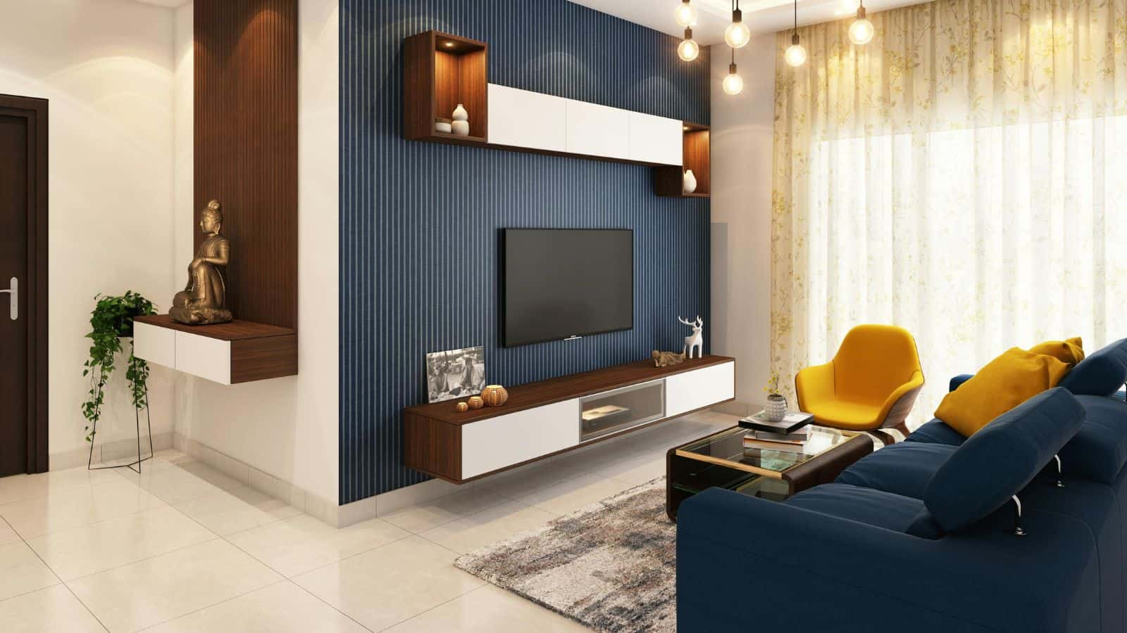 A modern living room with a yellow armchair, a blue sofa, and a dark wood and white entertainment unit against a blue accent wall. A flat-screen TV is mounted on the wall, and a decorative Buddha statue sits on a shelf. Large windows with sheer curtains allow natural light in.
