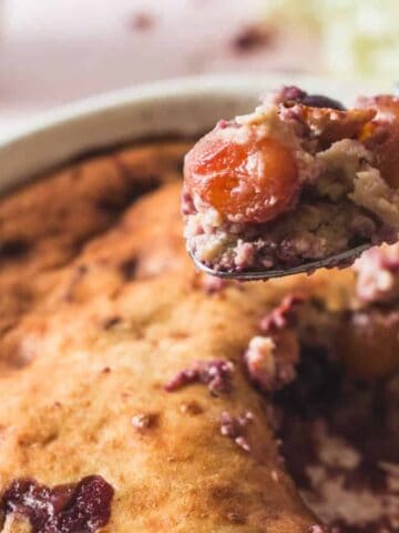 picking up spoon from cherry cobbler