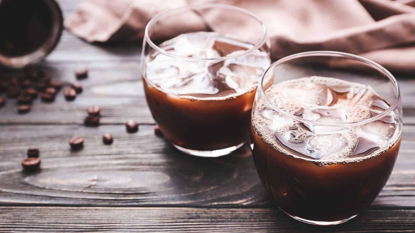 An image of two glasses of coffee with ice in them to keep them chilled.