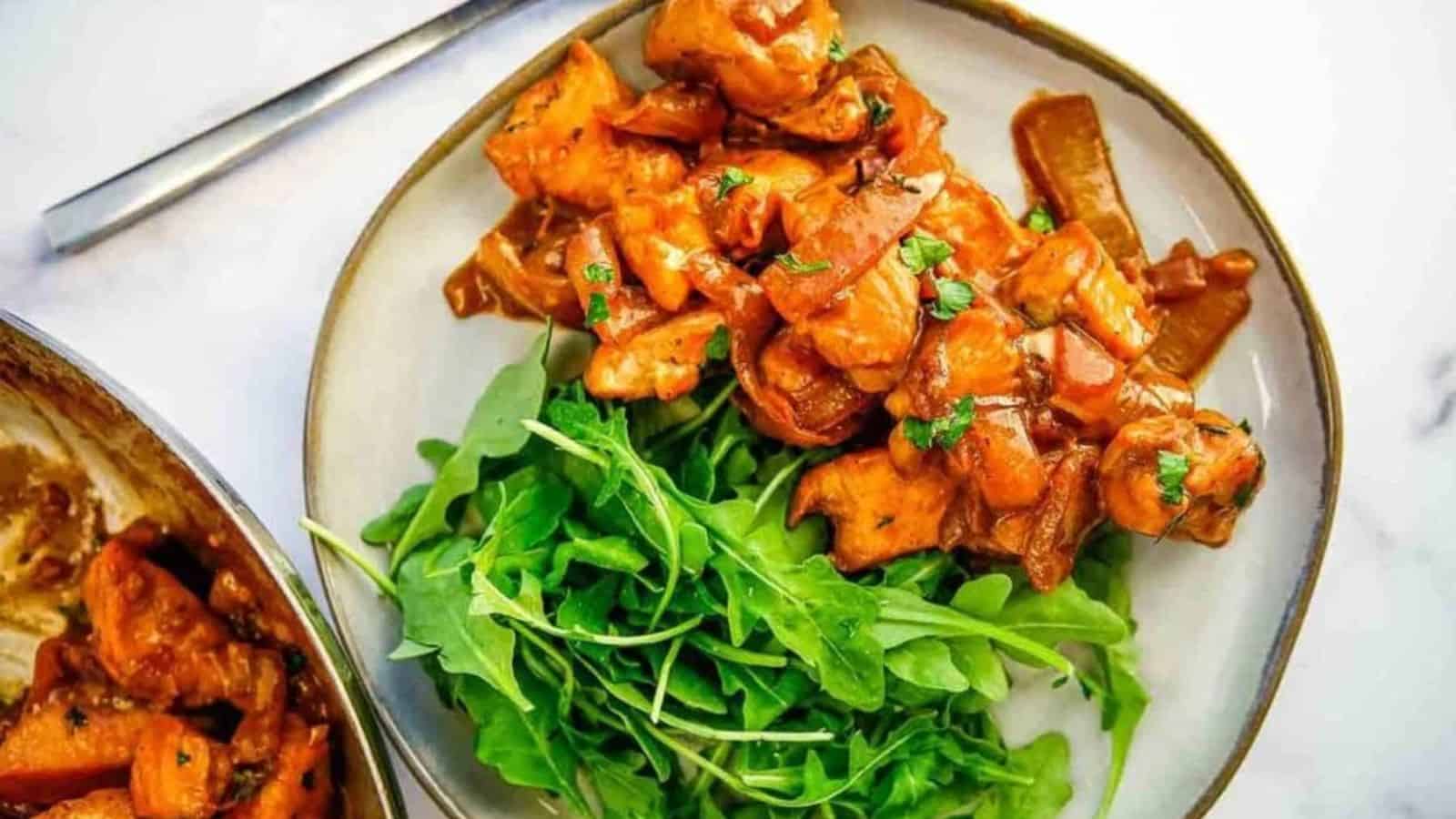 A serving of creamy balsamic chicken skillet next to a serving of green salad.