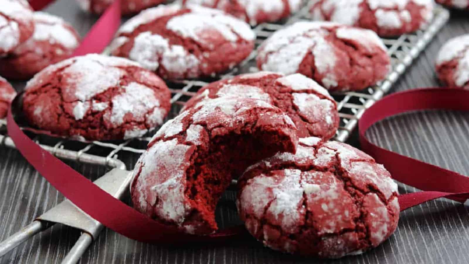 A cooling rack with red velvet crinkle cookies.