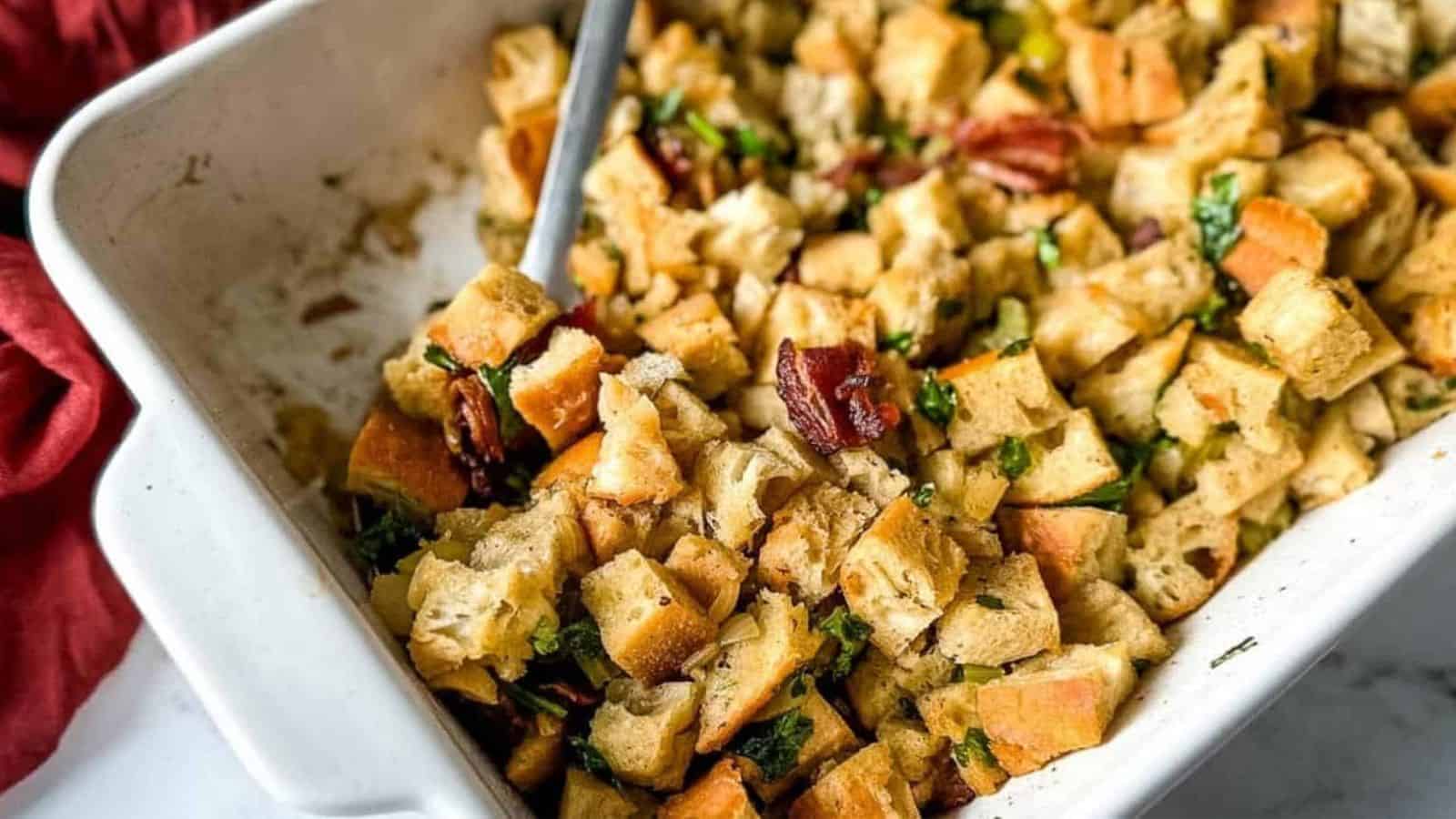 A closeup is shown of a baking dish full of bacon and sage stuffing.