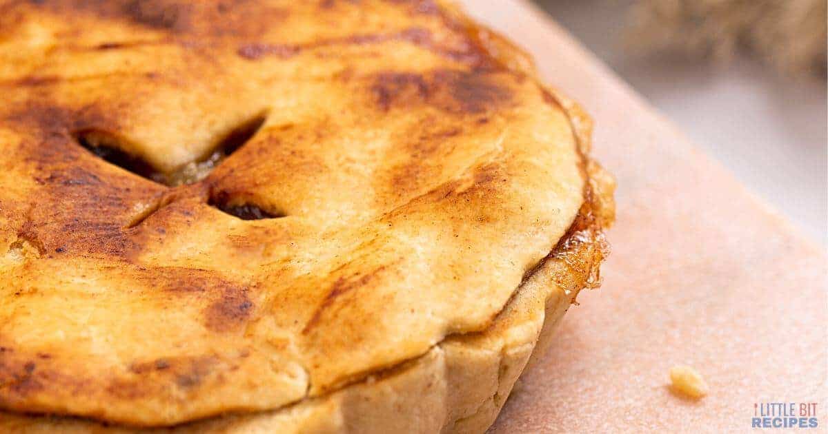 Mini apple pie on cutting board.