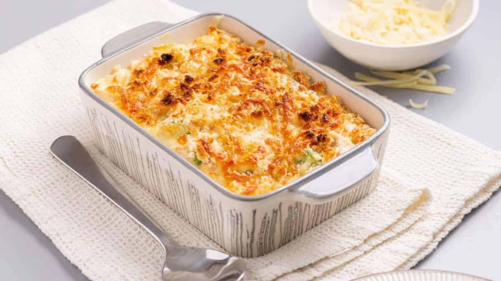 A casserole dish with cheese and broccoli on a napkin.