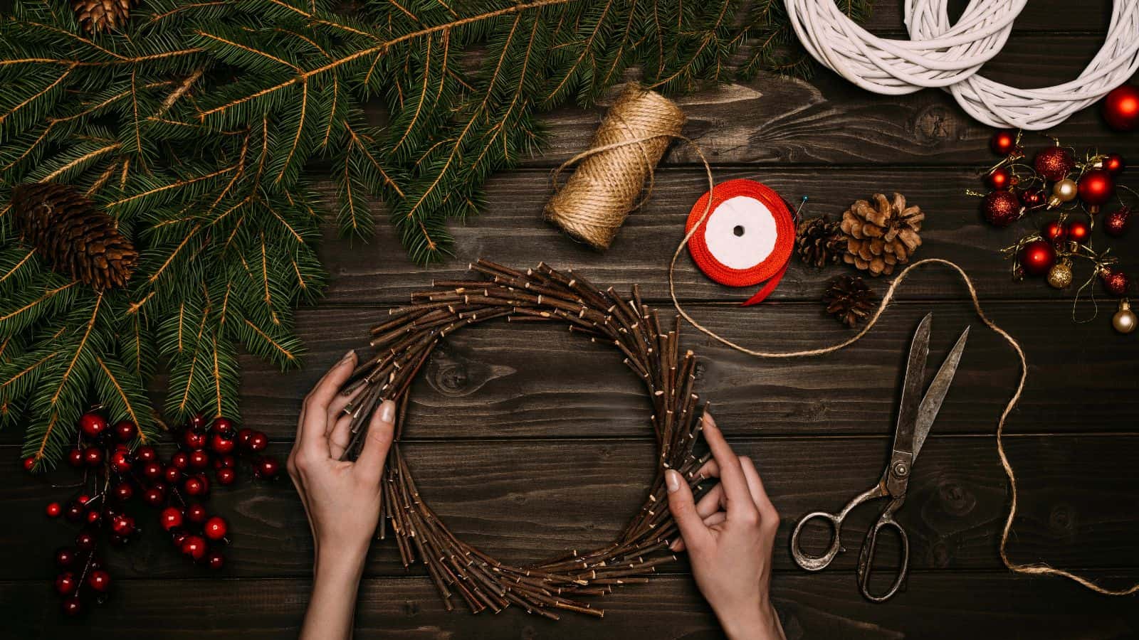 Hands of a florist making a holiday wreath.