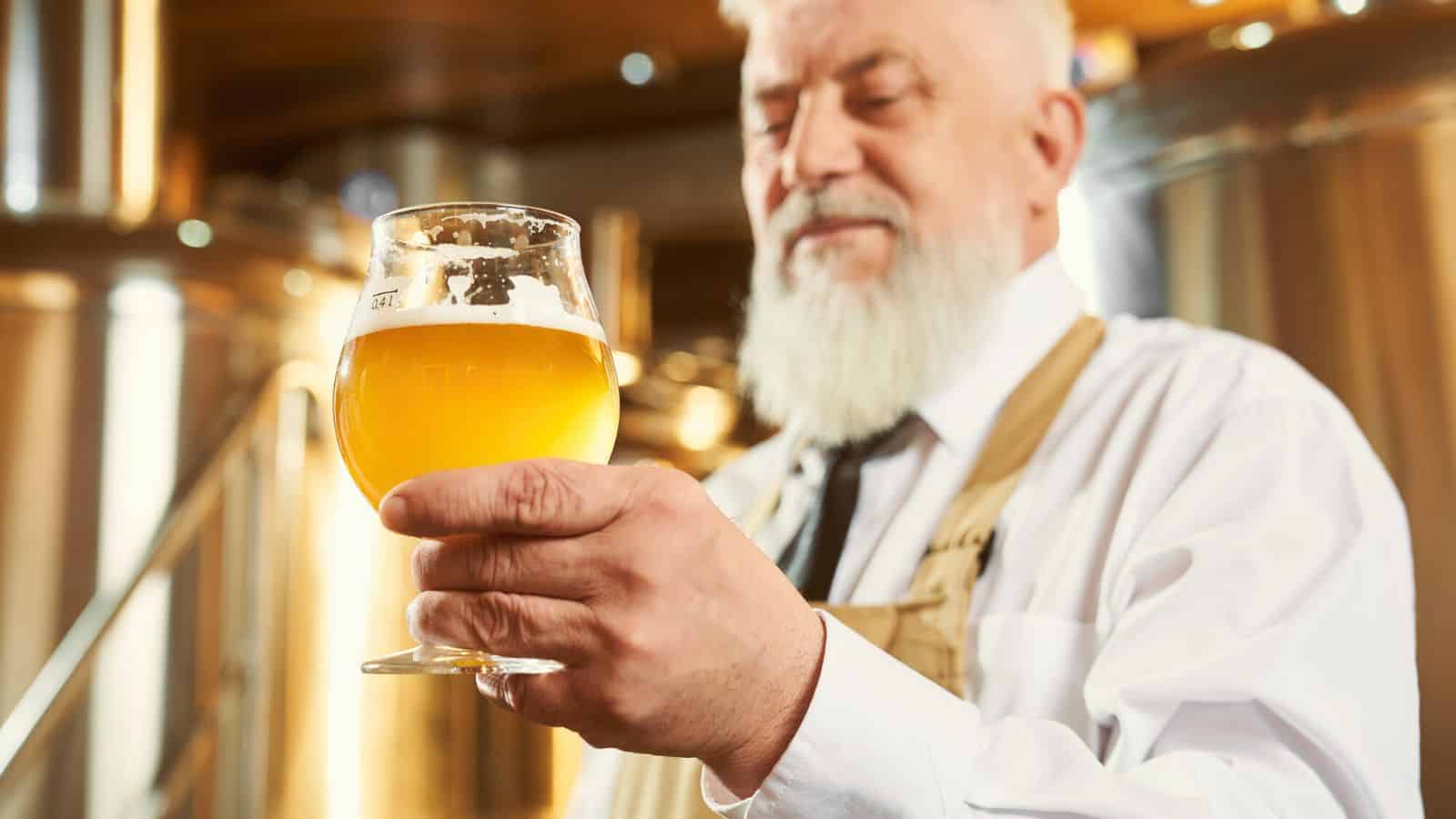 Old man looking at a glass of ale