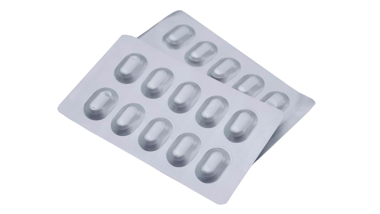 Two partially overlapping blister packs containing white capsules arranged in rows, each pack holding ten capsules. The packaging is silver with each capsule individually sealed in a clear plastic dome.
