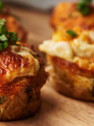 Egg Bites on a board with a little parsley on top.