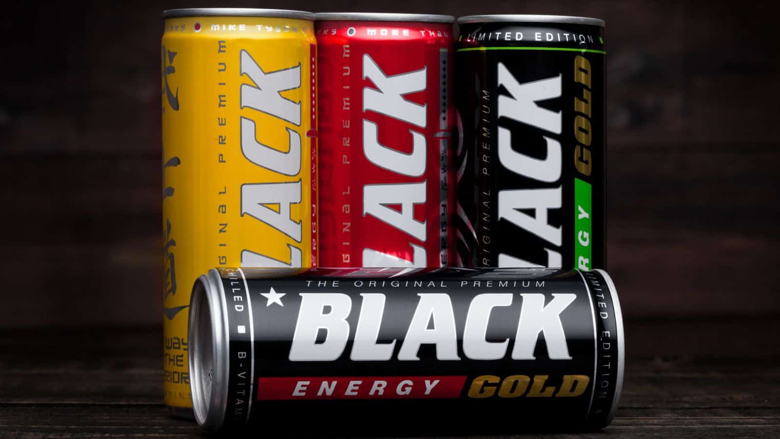 An image of four black cans with different flavors.