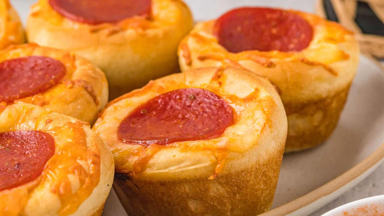 Pizza muffins on a plate.