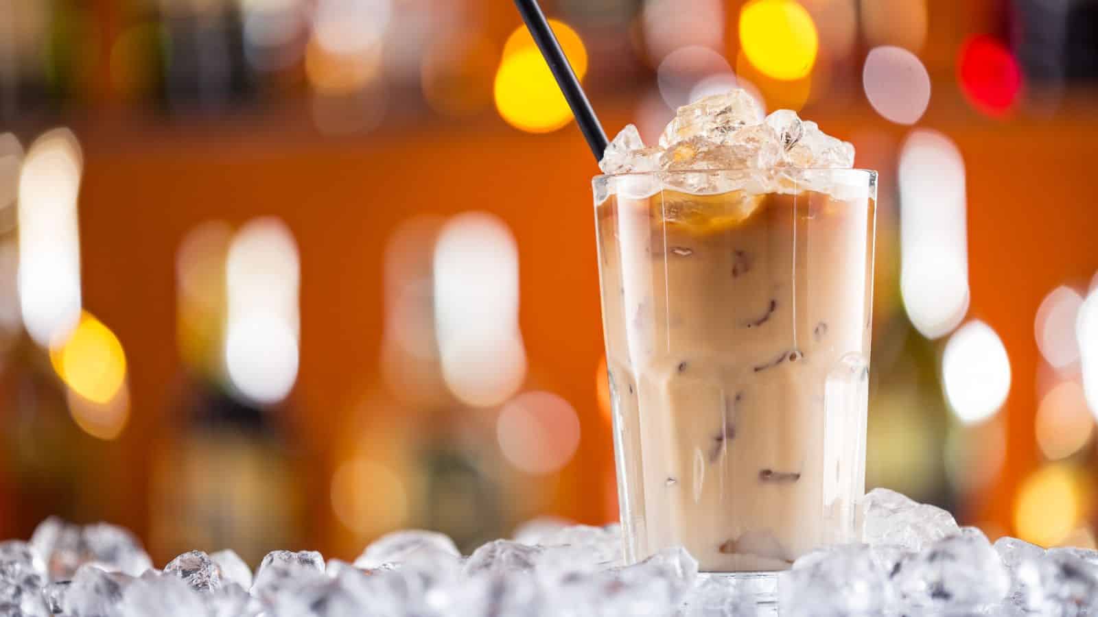 A glass of iced coffee with whipped cream.
