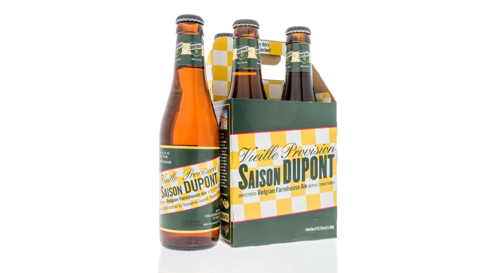 A six-pack of Saison Dupont Belgian farmhouse ale is displayed against a white background. Five bottles are in a cardboard carrier with a green and yellow design. One bottle is positioned in front of the carrier, showing the label clearly.