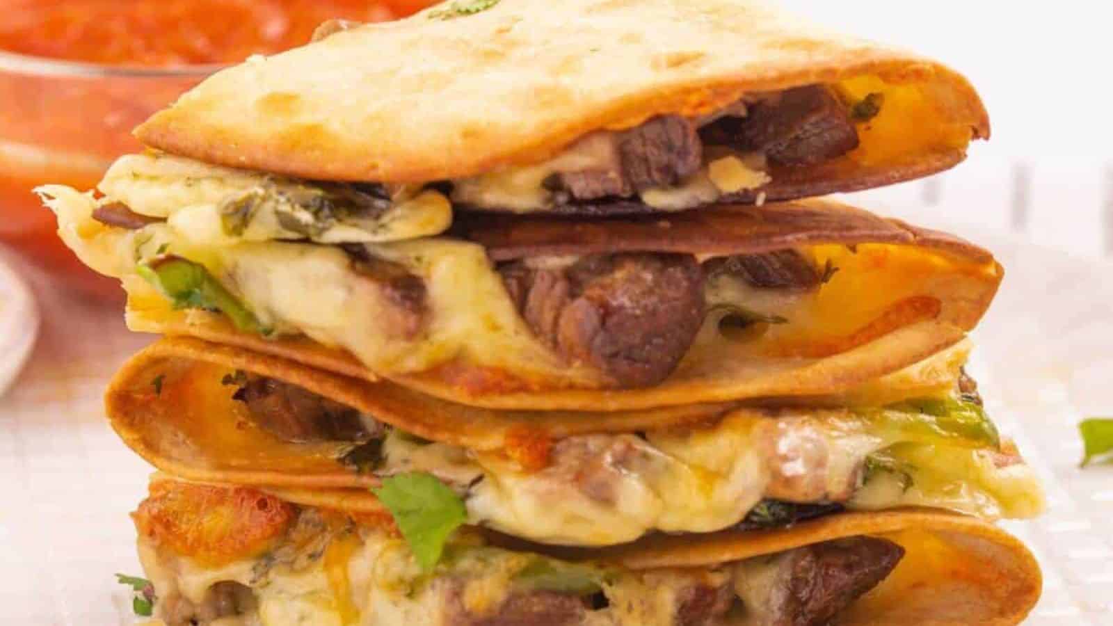 Stack of beef quesadillas on a plate.