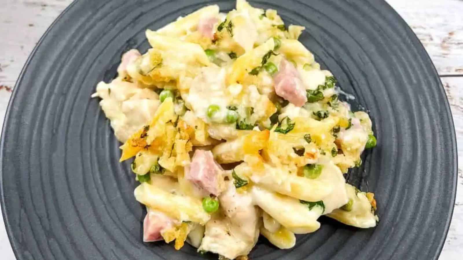 Chicken cordon bleu casserole on a black plate with a fork.