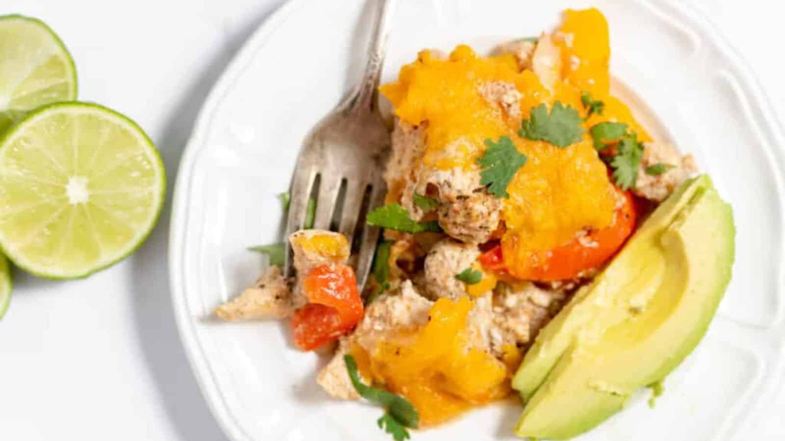 Chicken Fajita Casserole with avocado slices on the side.