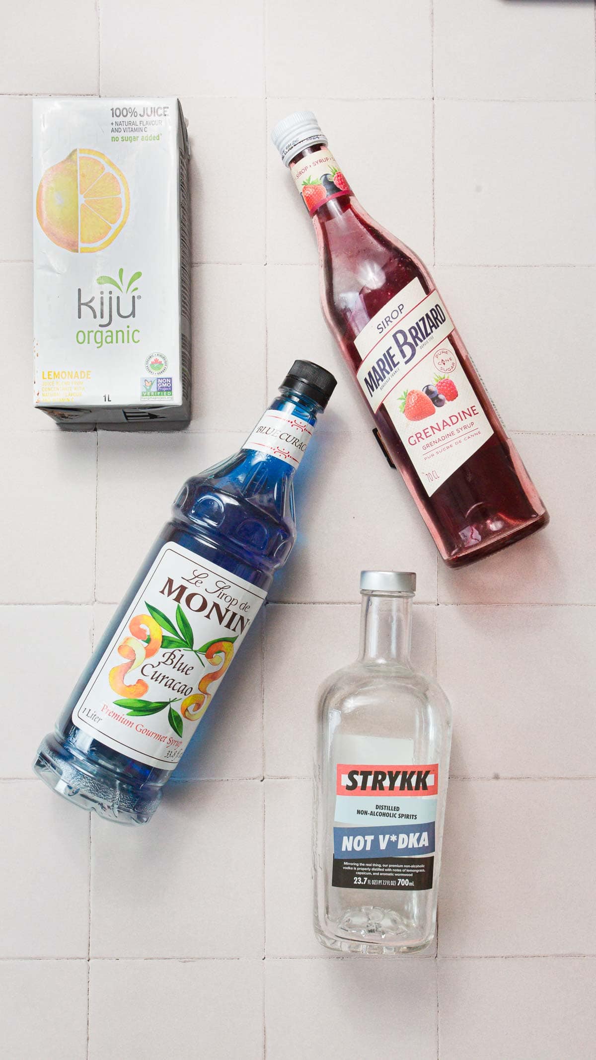 Red, white and blue lemonade ingredients next to each other . 