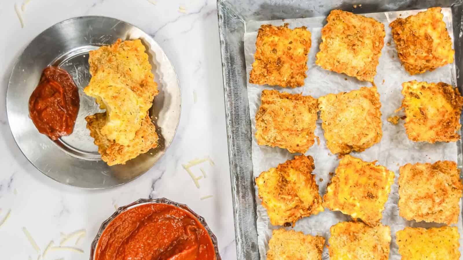 A hand dips a crispy, breaded zucchini chip into a bowl of marinara sauce.
