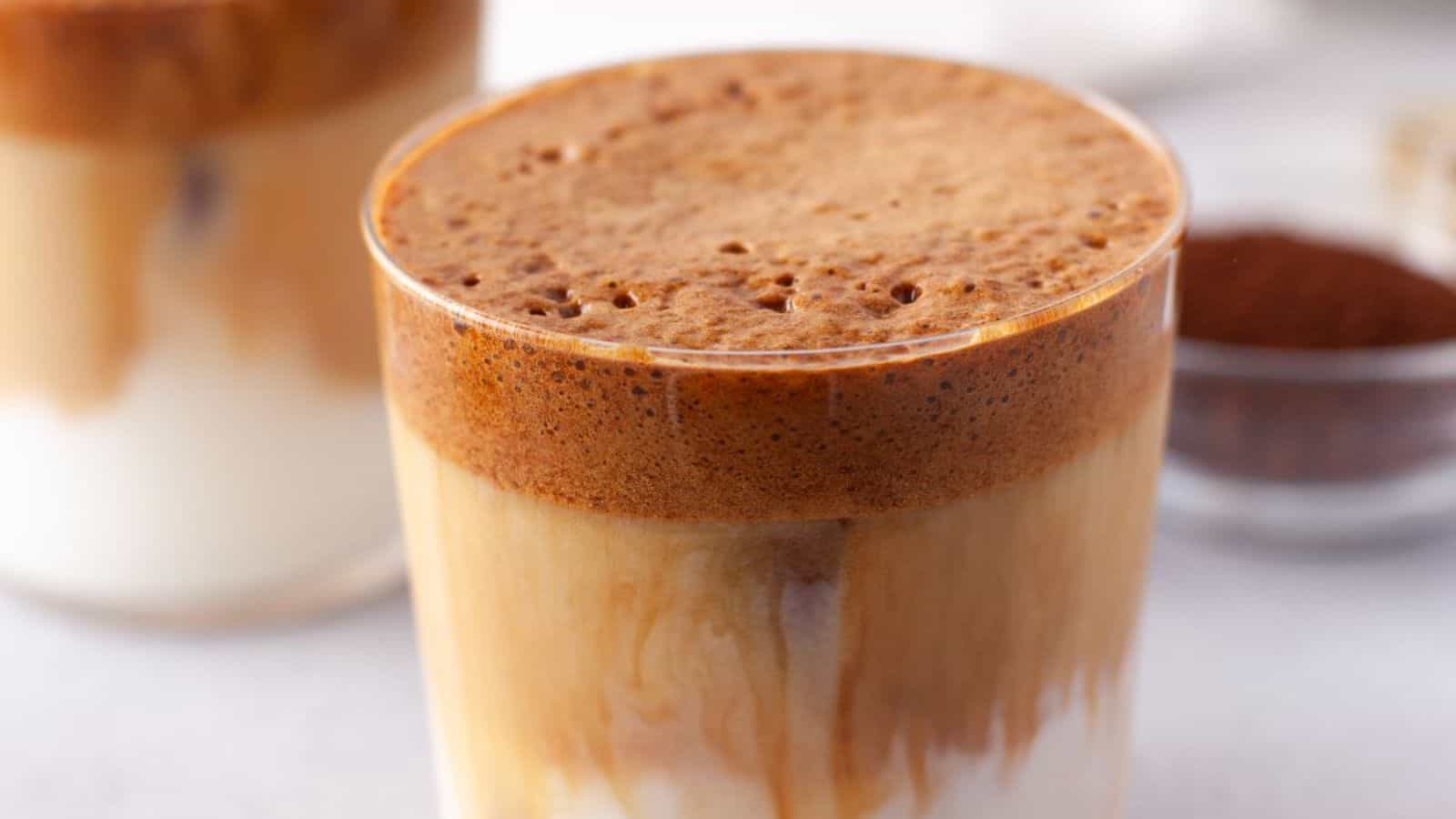 A glass of pumpkin spice whipped dalgona coffee.