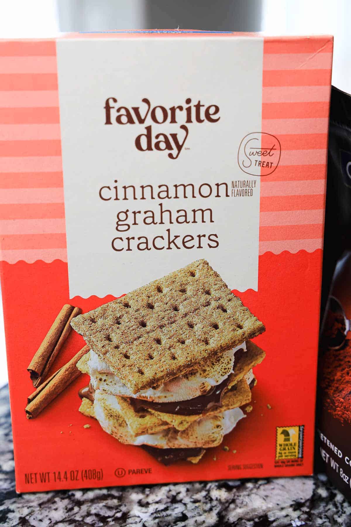 A box of Favorite Day cinnamon graham crackers with an image of s'mores, cinnamon sticks, and a tasty s'mores milkshake on the front.