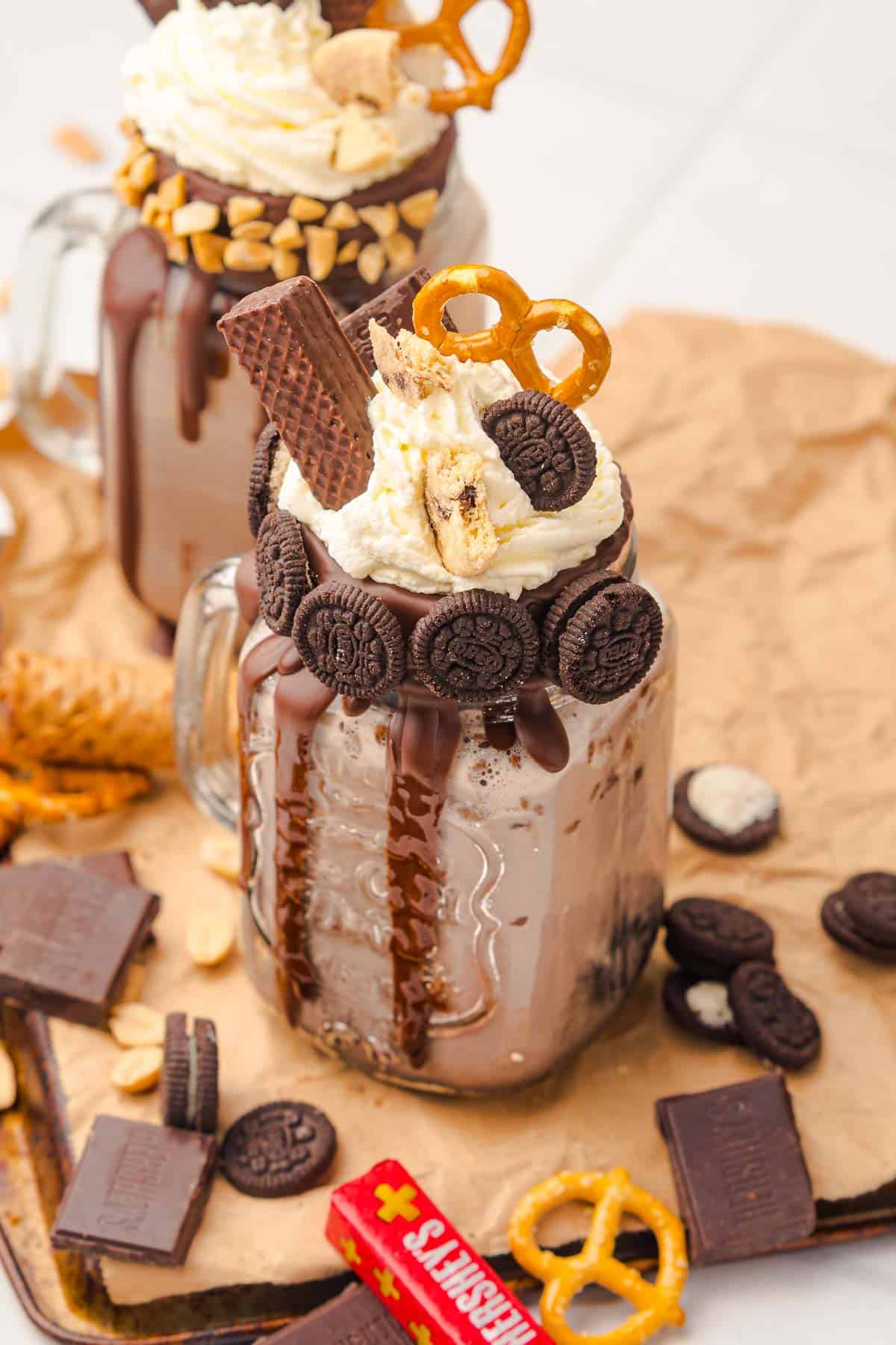 Indulge in a decadent Chocolate Freakshake&mdash;a rich chocolate milkshake in a mason jar, piled high with whipped cream, cookies, pretzels, peanuts, and chocolate for the ultimate treat.