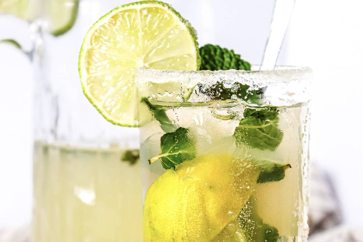 A glass of Virgin Mojito with lime, mint leaves, and a sugared rim, garnished with a lime wheel&mdash;an irresistible mocktail recipe perfect for any occasion.
