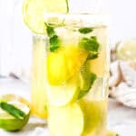 A tall glass of Virgin Mojito with lime slices, mint leaves, ice, and a lime wedge garnish on the rim—an irresistible mocktail recipe for refreshing moments.