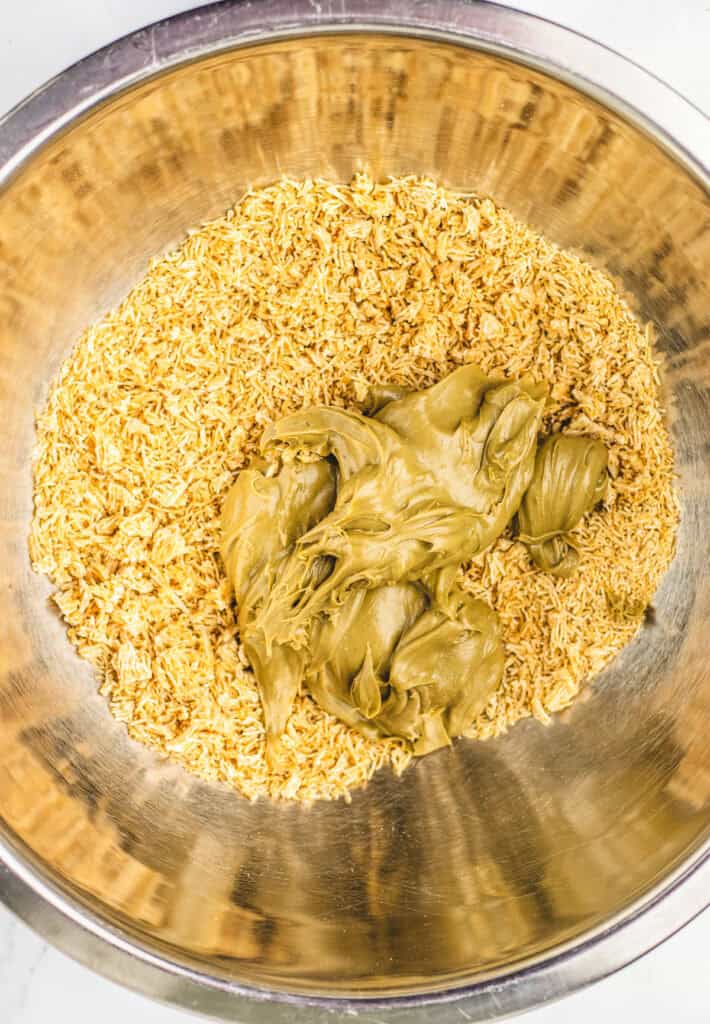 A metal bowl with uncooked ramen noodles and a large dollop of peanut butter, ready for a creative twist inspired by the Dubai Brownie.