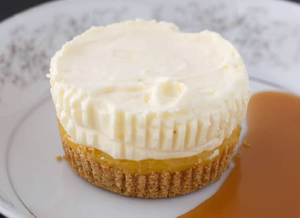 Pineapple Ice Cream Cake on a white plate next to a pool of sauce.