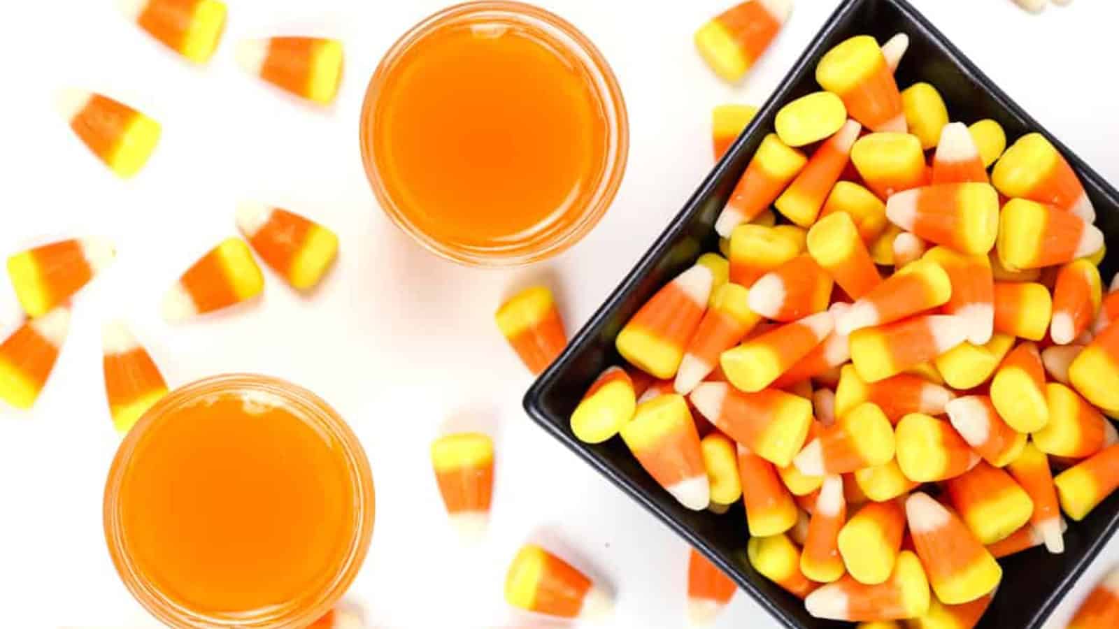 Candy corn vodka shots layered in yellow, orange, and white.